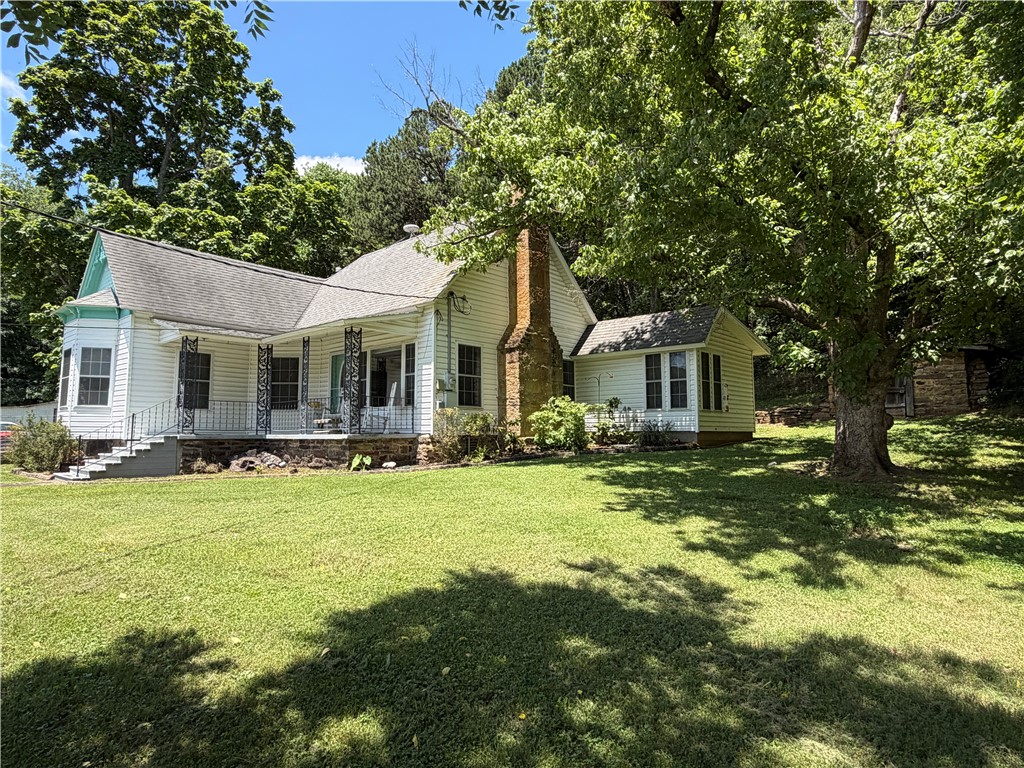 What a gem! This property sits in the heart of a quiet community and has fantastic Victorian farmhouse appeal. The warm and inviting 1384sqft, 2br/1.5ba home is fully remodeled yet abundant in original 1890's character. Inside, find an eat-in kitchen, office/bonus space, and handy hall storage pantry. The hardwood floors, bay window, and wood burning stove are nice touches. Outdoors, you find covered porches overlooking 3 useable acres with huge shade trees, raised bed gardens, and outbuildings for storage. Low maintenance vinyl exterior, rural water, OzarksGo fiber, natural gas plumbed to house, and highway frontage are other key features. Enjoy the White River, National Forest, and the beauty of the Ozark outdoors. The work has been done! You can own this treasured piece of community history!