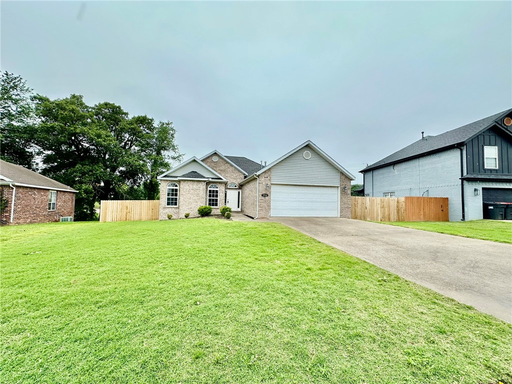 Features a cathedral ceiling in the living room, a cozy gas-log fireplace, and a functional kitchen with a pantry. The spacious primary suite includes a large walk-in closet, whirlpool tub, walk-in shower, and a double-sink vanity. Enjoy outdoor living on the large wooden deck with a full privacy fence. Conveniently located with easy access to the bypass for a smooth commute.**$250 non-refundable pet fee per pet**