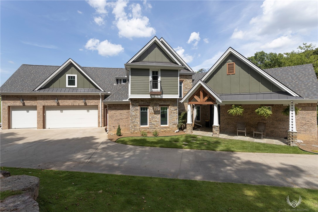 Are you looking for a private oasis? This captivating property has a pond and a spring fed creek running through the 3+ acre lot. This coastal craftsman home has had only one owner and lacks no detail. There is so much natural light from the casement windows that provide unobstructed views of a park like setting.  Main floor offers an open floor plan with 2 full bedroom en-suites and an office.  Upstairs you will find 3 additional bedrooms, 2 full bathrooms and a large sized bonus and/or game room.  Features include custom built-in cabinets, geothermal heat and air units, top rated zorro zoysia turf, new roof and an outdoor patio to relax in. The driveway is paved and private with a circular turnaround, providing plentiful parking outside or in the 3 car garage. All of this is located within the highly sought after premier Woods Creek Subdivision, a short drive to PC Marina, close proximity to the home office and the Bentonville square. This is too magnificent to miss out on!!