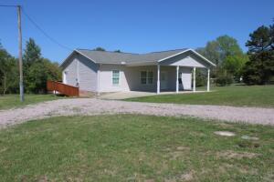 Looks Like New - 2 bedroom 2 bath home features handicap accessible level front and back entries plus master bath with roll in shower. Complete new interior paint, new vinyl plank flooring throughout, new Frigidaire range, micro-hood, dishwasher, and new water heater. Large front porch doubles as carport, rear deck off dining area with exit ramp. Home is all electric but has propane connection for extra gas space heater or fireplace. Located only 0.3 miles off pavement about 15 minutes from Harrison on 2 acres with near level yard.  Come See Today!!