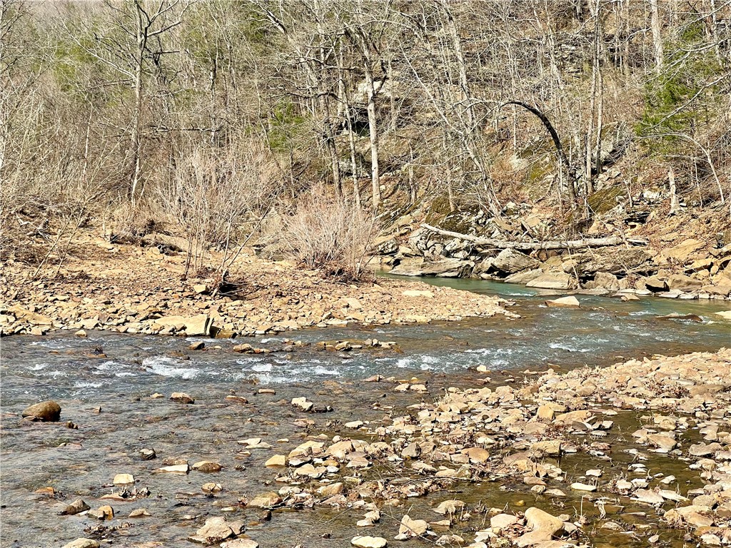 70 acres in the Ozarks within a 30 min drive to Fayetteville, AR. Escape to your own private oasis with this stunning recreational property, featuring scenic building spots, an off-grid cabin, and the tranquil flow of Lollars Creek right below the bluff line. Whether you're hunting, hiking, riding, or fishing for smallmouth in the deep swimming holes, this property truly offers it all. All hwy frontage to the entrance.