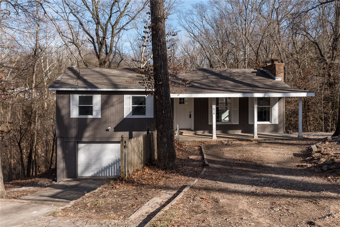 Completely remodeled home in wooded setting near Beaver Lake! Charming curb appeal with newly painted exterior, shutters, and front porch. Spacious and open layout with lots of natural light. Wide plank wood laminate floors throughout. White brick fireplace in living room. Dining room off the living room. Kitchen has painted cabinets, granite counters, and stainless appliances. Downstairs is a massive bonus space that is perfect for entertaining and would be a great game room or media room! This home is a MUST SEE!