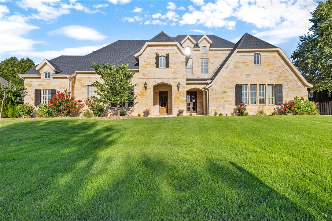 Welcome to Thornbury, north Springdale’s most esteemed address! From its beautifully landscaped cobblestone entrance, through the quaint covered bridge, and just past the private neighborhood trail connecting to the Greenway, you’ll find this stately limestone estate-style home on a half-acre. Teeming with rich wood accents, this custom stunner features five bedrooms and extras like the butler’s pantry, ice machine, hand-scraped flooring on the main level, brand new carpeting, a warmly paneled office and large upstairs bonus. Outside, shoot hoops, enjoy a refreshing summer dip in the heated diving pool, or kick back on  the covered patio with a cozy outdoor fireplace. This incredible extended living space is an entertainer’s dream, boasting an outdoor kitchen with wonderful bar seating and an entrance into a full bath just inside. New roof in 2021. Don’t miss a chance for your private showing now— with plenty of summer and fall to soak up all the pleasures of this gorgeous retreat!