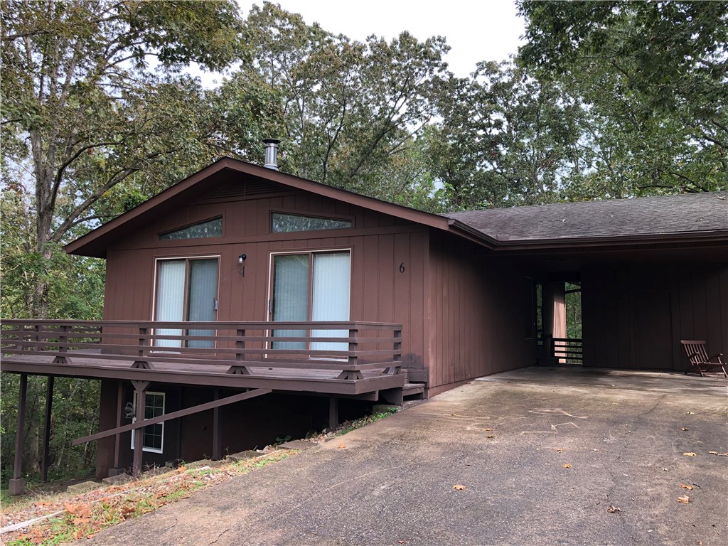Cozy 2 bedroom 2 full bath home in Bella Vista. Located at end of cul-de-sac, very private. Wood floors throughout, large family room, all appliances, breakfast nook opens to huge 2nd level wrap around porch, kitchen has plenty of countertop space and cabinets, spacious bedrooms, large closets. Looks like a resort property located in the hardwoods of Bella Vista. 2 car capacity carport, wonderful neighbors, minutes from everything.