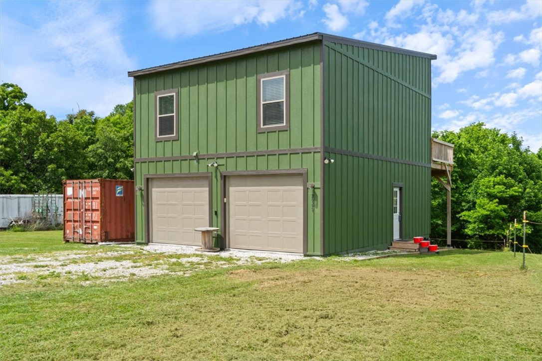 Charming new construction nestled on 4.59 acres in a peaceful country setting! Built in 2025, this 2-bedroom, 1-bath home offers modern comfort with the privacy you’ve been looking for. Featuring durable wood laminate flooring throughout, the home is designed with a functional layout that includes garage space on the lower level and comfortable living quarters above. Enjoy the quiet surroundings from your private drive, all while being outside city limits for added flexibility. A perfect blend of rural tranquility and low-maintenance living!