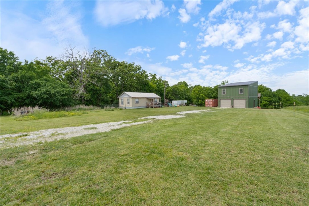 Charming new construction nestled on 4.59 acres in a peaceful country setting! Built in 2025, this 2-bedroom, 1-bath home offers modern comfort with the privacy you’ve been looking for. Featuring durable wood laminate flooring throughout, the home is designed with a functional layout that includes garage space on the lower level and comfortable living quarters above. Enjoy the quiet surroundings from your private drive, all while being outside city limits for added flexibility. A perfect blend of rural tranquility and low-maintenance living!