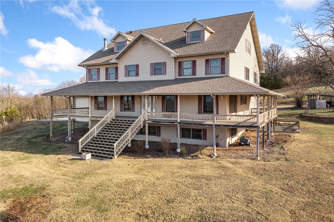 One-owner, custom-built 9,600 sq ft home offering exceptional space, privacy, and panoramic views in the Arkansas Ozarks. This impressive property features 6 bedrooms plus a bonus room, 4 full baths, and 2 half baths. Designed for comfort, durability, and large-scale entertaining, it’s ideal for a Bed & Breakfast, Airbnb, or corporate retreat. The home easily accommodates guests with its generous layout and multiple living areas. Key features include a whole-house generator, in-house sprinkler system, outdoor Hardy wood furnace, propane cooktop, multiple HVAC systems, and a brand-new roof (2023). It also offers a spacious three-car garage and solid construction throughout. Available on ~10 acres or ~40 acres (with pond and barn). Enjoy absolute privacy, usable land, and breathtaking long-range views from every level. Located just outside Big Flat and Harriet, with Marshall and Mountain View both about 30 minutes away.