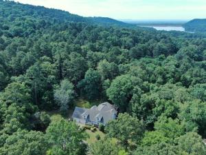 Get away without going away!  This beautiful home sets on 3.5 wonderful wooded acres  with a peaceful stream running through it.  There are two living rooms to enjoy with your family and friends and a gorgeous covered deck to make the most out of every season.  The 1910 sqft home has room to spare including additional storage in the attic and access to an unfinished basement area for all your projects, tools, and toys! All of this on the edge of Russellville only minutes from work and shopping!