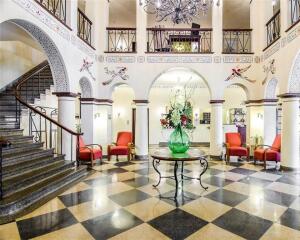 Trendy, yet historic boutique hotel featuring Spanish inspired archways and architecture. Includes interior corridor hotel with restaurant/ bar, covered parking garage, plus parking lot. Mail level lobby features stately staircase, elevator, and grand chandelier in soaring ceiling of 2nd floor mezzanine. Restaurant/Bar on main level with connecting covered terrazzo. 2nd and 3rd floors house a variety of upscale rooms and suites, laundry, and storage. Some rooms currently being updated. (Subject to Restaurant/Bar Lease). Financials subject to Seller approved proof of funds/pre-approval letter. Proposals subject to Seller's attorney approval (Option of Seller). Information subject to change. Sale subject to obtaining all necessary releases. No PD.