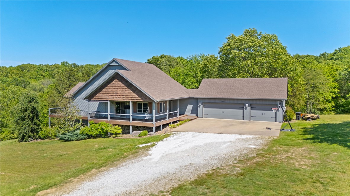 Beautiful home on 5.00 acres with an in-ground pool, surrounded by pasture land and trees, perfect for a hobby farm! Just 10 minutes from the new Walmart Campus, this property offers the ideal blend of convenience and tranquility. The interior features a stunning kitchen with a gas range, huge waterfall island, and custom cabinets. Relax in the vaulted living room with breathtaking panoramic views. The primary bedroom boasts a private balcony and an impressive ensuite with a custom-tile shower, sauna, and spacious closet. Entertain in the expansive walkout basement, complete with a large living, game area, wet bar, and two additional bedrooms. Tons of storage throughout! 4th bedroom is ideal as a flex room, nursery, or office (not a bedroom) Refrigerator, washer, and dryer conveys. This property is perfect for buyer's seeking privacy without giving up quick access to schools, restaurants/shopping, and trails! Schedule your showing today!