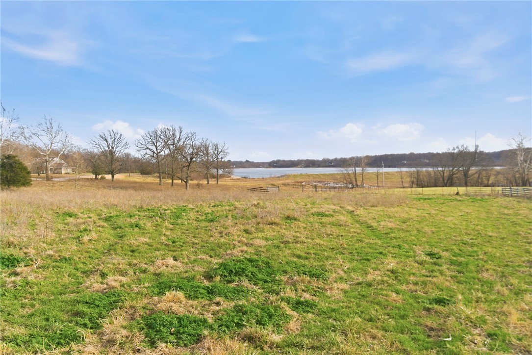 Rare opportunity in Elm Springs-14.43 scenic acres with open views of Elmdale Lake. Gently rolling and picutresque, this property is ideal for a private luxury estate or a builder's showcase project. Peaceful setting with endless potential.