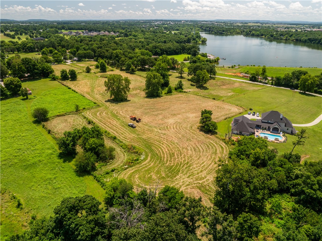 Rare opportunity in Elm Springs-14.43 scenic acres with open views of Elmdale Lake. Gently rolling and picutresque, this property is ideal for a private luxury estate or a builder's showcase project. Peaceful setting with endless potential.