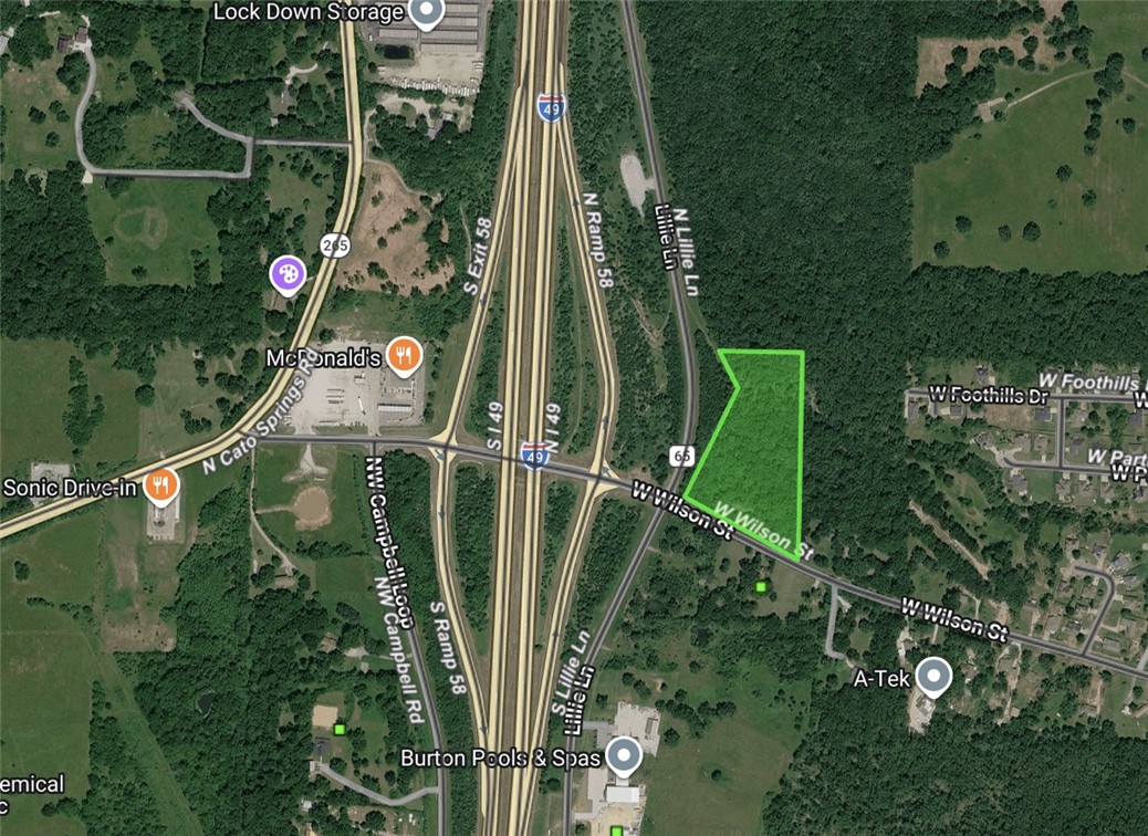 Prime commercial development opportunity zoned C-3 with over 500 feet of road frontage on W Wilson St and excellent sign visibility from I-49!  Zoning allows for a wide range of commercial developments, including retail centers, professional office spaces, medical clinics, or restaurant/fast-food establishments with high highway visibility. Boasts incredible visibility with an estimated daily traffic count of over 43,000 vehicles on the adjacent corridor. While county records indicate 5.08 acres, a 2021 survey shows 5.88 acres (attached in supplements). All utilities are available at the street, and public sewer is located just across the road (requires a bore to access).Seller is related to listing agent.