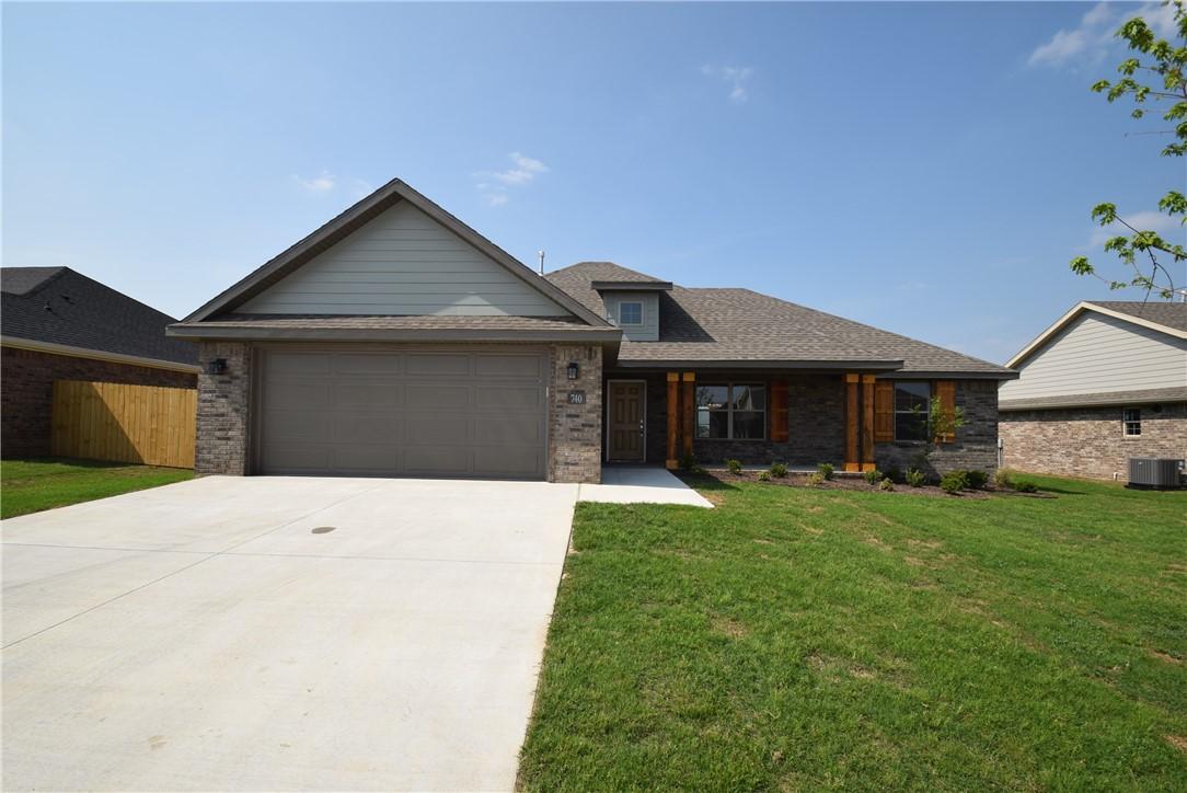 Welcome home to this like-new gem in the sought-after Hickory Meadows community in Tontitown! From the inviting front porch to the bright, open-concept layout, this home is designed for comfortable everyday living and effortless entertaining. The spacious kitchen features custom cabinetry, granite countertops, stainless steel appliances, and a large island that's perfect for gathering with family and friends. Secondary bedrooms offer generous closet space and flexibility for kids' rooms, guests, or a home office, while the shared full bath provides added convenience. The private primary suite is a relaxing retreat with dual vanities, an oversized walk-in closet, and plenty of room to unwind. You'll also appreciate the energy-efficient tankless gas water heater, providing endless hot water. Outside, enjoy all the neighborhood amenities, including a resort-style community pool with pavilion and a playground where kids can play and neighbors become friends.