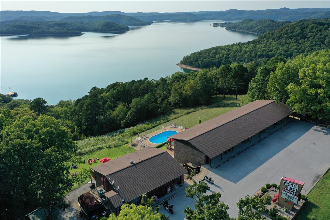 Incredible investment opportunity in the Ozarks! This iconic and well-maintained 23-unit motel offers stunning views of Beaver Lake and is located just minutes from Lake Leatherwood and the Beaver Dam. Trip Advisor ranked Pointe West Resort #1 for 8 years vs their 35 local peers. Each unit features a unique theme, creating a memorable guest experience that drives strong, repeat business year after year. The property includes on-site manager’s quarters, ample parking, a swimming pool, and peaceful natural surroundings. Guests return for the charm, the scenery, and the unmatched location—perfect for boating, fishing, biking, and hiking. With loyal clientele and a reputation for meticulous upkeep, this turnkey motel offers stable income and growth potential. It’s clear from the moment you step on-site—the owners take pride in every detail. Don’t miss this chance to own a profitable piece of paradise in Northwest Arkansas!