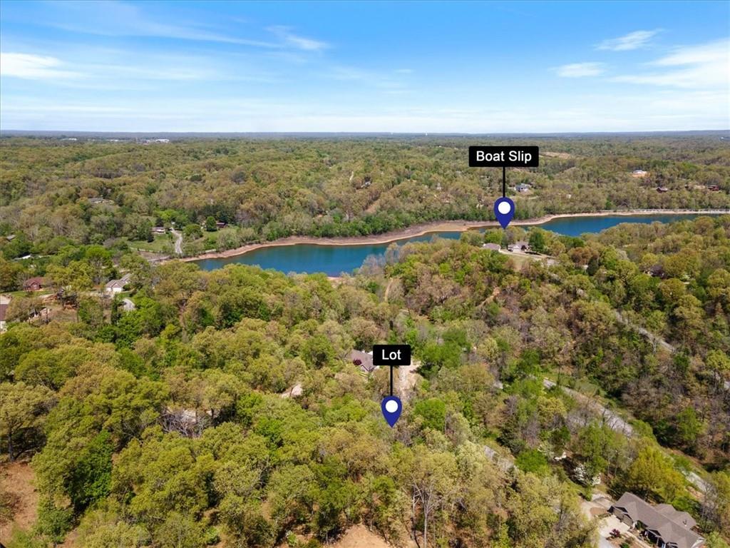 Hard to Find--Great Buildable Lot that includes a 24 x 10 Community Boat Slip on Beaver Lake. Paved drive to the Community slip with ample parking. Fantastic location just 5 minutes from downtown Rogers. Beautiful Mountain Lake Estates Subdivision. Come build your custom dream home on this 1.07 acre lot. Peaceful neighborhood built in and around the lake with hills and views. Seller has plans for a 3000 SQFT home that they are willing to share with a buyer. Buyer to confirm utilities at the street.