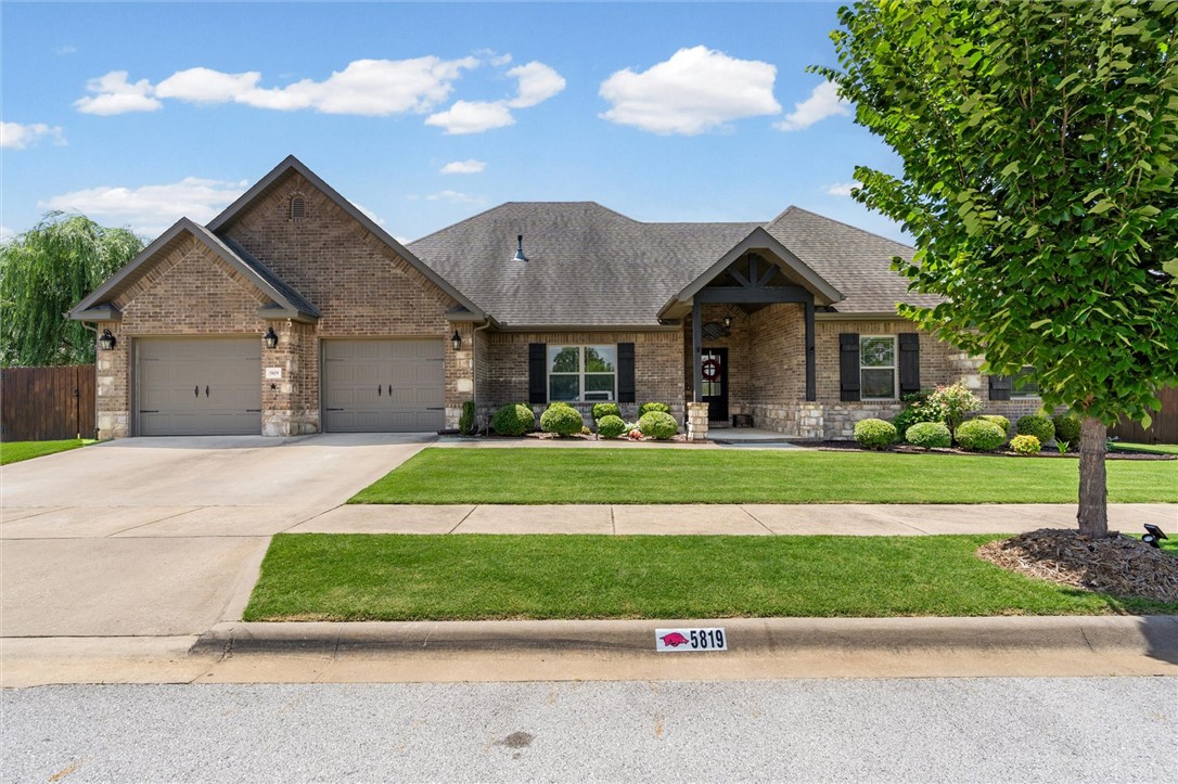 Welcome home to 5819 W Cane Hill Drive in Fayetteville! This beautifully crafted home offers 3 bedrooms, 2.5 bathrooms, plus a versatile flex space perfect for a home office, playroom, or 4th bedroom. Quality finishes shine throughout with custom cabinetry, granite countertops, custom trim, & tall kitchen ceilings that create an open, inviting feel. Large walk-in closets provide plenty of storage. Enjoy year-round outdoor living on the screened-in covered patio featuring an outdoor fireplace. Situated on a corner lot, the home also offers a stained privacy fence, a professionally installed French drain system with decorative rock, & a storage building for added convenience. The garage is equipped with insulated doors & a mini-split system, making it ideal for a workshop, gym, etc. The refrigerator conveys with the home, and the HVAC system has been well maintained. Combining thoughtful upgrades, quality craftsmanship, & exceptional indoor & outdoor living, this move-in-ready home is one you won't want to miss!