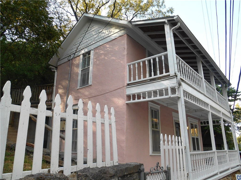 Fantastic location in downtown Eureka Springs.  This would make a great retail or office space with living quarters.  This home would also be great for a weekend get-away, full time or part time rental.  Newly remodeled with a single car garage which is hard to find.  New tile, tile shower, carpet, paint, part of the roof and so much more!  Large fenced in back yard, even includes original stain glass window.  This is a gem!