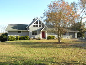 LAKE FRONT home on beautiful Piney Bay! This lovely 3 bedroom 2 bath home features tall vaulted wood ceilings in the living room with a rock fireplace and loft area. If you are a water lover, you will appreciate the direct water access and the stunning view from your back deck. Recent updates include granite counters, new tile backsplash, new flooring, and covered parking for your boat or additional cars. Complete with walk-out basement workshop/hobby room.