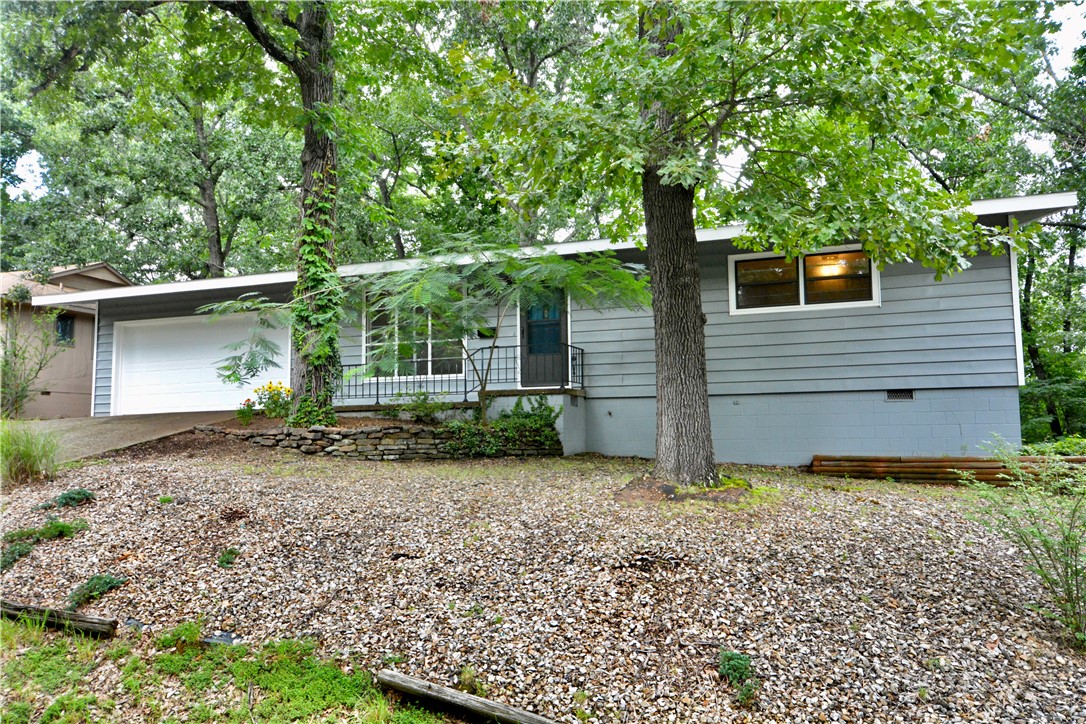 Very nice 2 bedroom , 2 full bath home with wood flooring through-out !  Bathrooms have been updated , primary bathroom has been totally redone !  All interior walls have been repainted .  Wonderful 11 x 22 sunroom with lots of windows . ( sunroom has window a/c unit , it has been included in total square footage ) 
This property is located with-in walking distance to Lake Avalon . Minutes to Bella Vista Country Club & Tanyard Creek Golf & Recreational area !  The price also includes an extra lot (lot 14) that is directly behind house . New roof installed