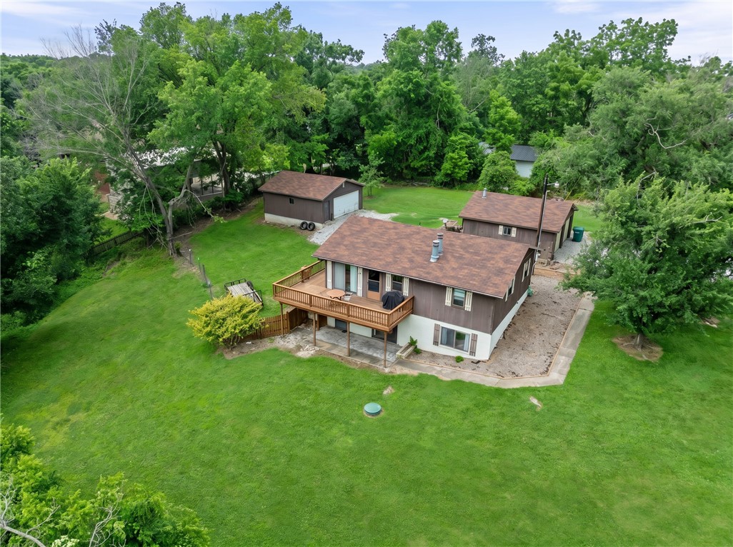 Situated on 4.45 acres, this property offers the perfect blend of quiet living, flexibility, and income potential with the opportunity to combine a primary residence & home-based business! The house features 2 kitchens, 2 living rooms with gas fireplaces, 3 bedrooms, & 2 full bathrooms creating an ideal setup for multi-generational living, private guest suite, or separate living quarters. The land presents an opportunity to add an ADU or tiny homes, giving you rental income potential. Two 2-car garages plus room to park an RV! Currently zoned commercial. New septic in 2024. Paint & laminate flooring in 2023.
