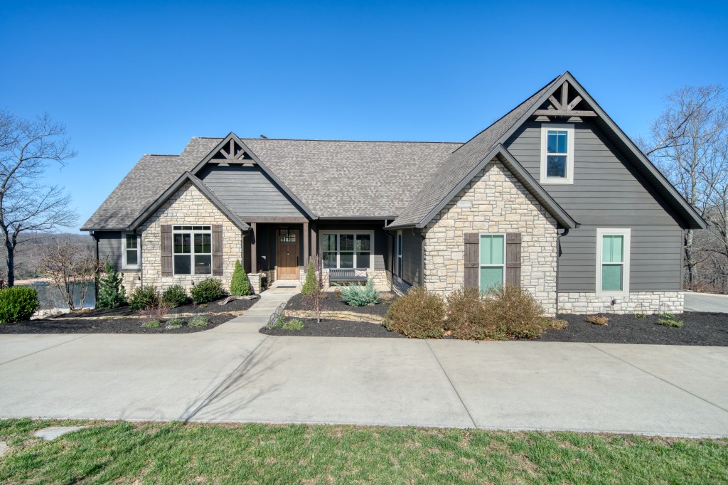 This amazing package is a rare sight! A main home with a great lake view, a guest house near the waters edge, and lake access to your own 2-slip private dock! The gorgeous 4 bed/4 bath, 4618 square foot main home sits above the cozy 1 bed/1 bath, 672 square foot “boat” house, and both are ready to entertain you and your friends! This home was recently constructed and has been excellently maintained! Stylish textures, colors, and materials flow throughout both houses and give this property a calm and fun feel. Amenities include concrete driveways and extensive landscaping, very large heated/cooled basement shop/hobby room, hot tub, screened deck with gas fireplace and wet bar, water treatment system, custom lighting, concrete security room, large bonus room above the garage, 2 whole house generators, security cameras, beautiful limestone walls and firepit hangout, 30x40 concrete shop foundation, and even wifi, lockers, and lifts at the dock! Literally too much to list and most furniture and furnishings are included!