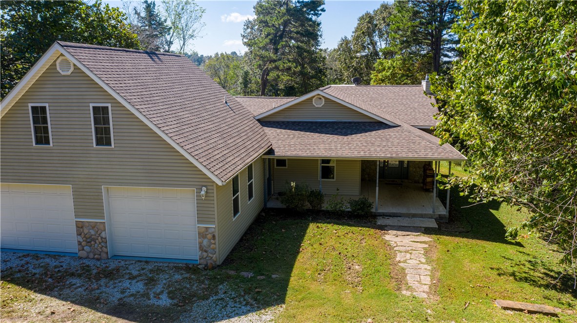 WOW! WHAT A PROPERTY! Enjoy this home on 1.32 acres with a short walk to co-owner BOAT DOCK on Beaver Lake and 750 sqft shop. Main home offers elegant etched glass entry, comfy living room with wood-burning fireplace and big windows to gaze upon the trees, kitchen with granite tops&an island, master suite with walk-in shower & guest bdr with bath, wood&tile flooring throughout&extended garage! Full upstairs apartment with outside entrance for privacy, kitchen,bath and more! Call today!!!