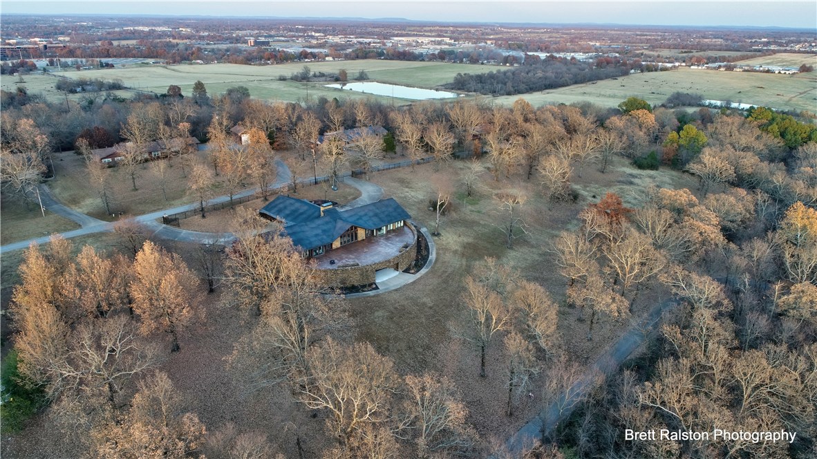 Timeless, stately, and luxurious one-of-a-kind estate. Impeccable native stonework in Frank Lloyd Wright “Round House” type architecture nestles on 2.73 acres of scattered oaks (adjoining 2.5+/- acres available). Totally remodeled, perfect for life-style and hosting small or large gatherings. 20’ 2-sided contoured native hand carved curved stone wall incorporating great-room fireplace for excellent entertaining atmosphere. 3 fabulous kitchens! Walnut throughout the home, study, great room ceilings, custom spiral staircase, and each interior door with Sherle Wagner (same as The White House!) brass hardware. New plush carpeted bedrooms. Castle-like setting, wrought iron chandeliers, and linen pendent lighting selected to highlight architectural design. Interior design touches are too many to list. New furnishings convey! Extra-large bedrooms & closets/storage space, fitness room with full bath & steam spa, shower, large game area, spacious home theater and heated/cooled 3,600 sq.ft garage. Worth the trip to come see!