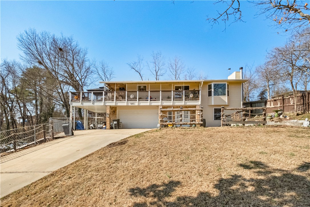 Beautiful 4-bedroom, 2.5-bath home situated on a peaceful .69-acre lot near Beaver Lake. Enjoy a quiet setting with scenic views and easy lake access—just a 4–5 minute golf cart ride to the water. This home offers abundant storage throughout, perfect for everyday living or weekend lake life. Relax or entertain on both the front and back decks while taking in the surroundings. RV storage and a second garage/shop building provide plenty of space for boats, toys, or hobbies. A rare combination of privacy, functionality, and proximity to the lake—ideal for full-time living or a lake retreat. $4,000 lender credit also being offered by preferred lender. Schedule your showing today!