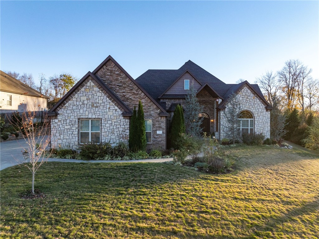 Discover luxury, and entertainment in this custom-built home in one of  the most desired neighborhoods- The Thornbury Subdivision. Boasting 3 beds, 3 bath, office/optional 4th bedroom this home is filled with exceptional custom features throughout.  The great room impresses with its 24 ft. vaulted ceilings and a floor-to-ceiling stone fireplace, flowing into the chef's kitchen equipped with industrial-grade appliances, large island and quartz counters.   The resort-style backyard oasis steals the show featuring a heated pool with 4 waterfalls, hot tub and professional landscaping. The owners suite is a true retreat, offering high ceilings, access to the patio/pool, a custom walk-through shower with spa system and heated floors. Additional highlights include a 4 car garage with a dog wash station, built in shelving, proximity to I-49, top schools, shopping, community park and the Razorback Greenway trails. This thoughtfully designed one level home is perfect for any lifestyle.  Request the full upgrade list today.