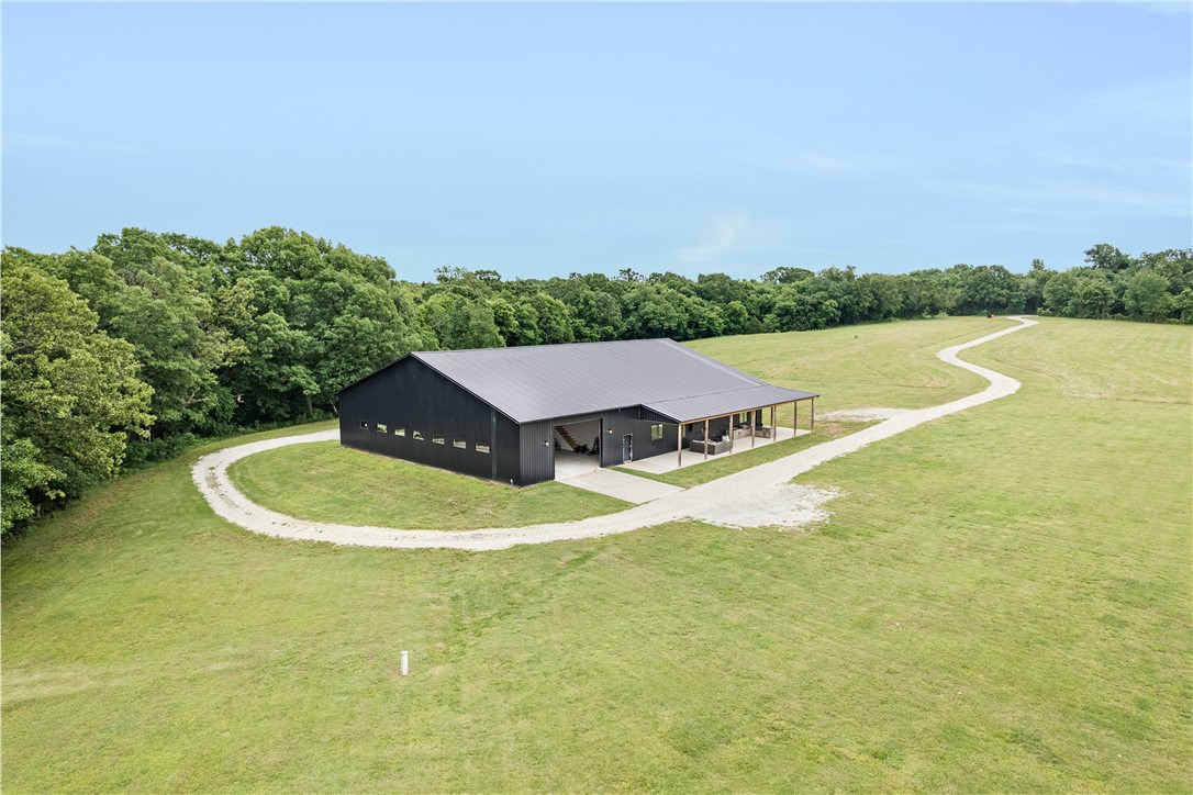 Discover an extraordinary opportunity to own a luxury estate surrounded by 140 breathtaking acres in Summers. Offering approximately 4,506 sq ft, this stunning 5-bedroom, 3.5-bath home blends elegant design with peaceful countryside living, featuring soaring ceilings, large windows with scenic views, and a spacious living area flowing into a chef’s kitchen with an oversized island, abundant prep space and butler’s pantry. The primary suite serves as a private retreat with a spa-like bath featuring a large walk-in double shower, soaking tub and spacious walk-in closet with direct access to a media room and wet bar. Additional bedrooms provide flexibility for guests or office space. The property also includes an attached 3,800+ sq ft shop, offering incredible space for storage or equipment. Outdoors, enjoy a fully equipped outdoor kitchen and grill area perfect for entertaining while taking in the peaceful scenery. This exceptional property offers luxury, privacy and beautiful countryside living in Summers.