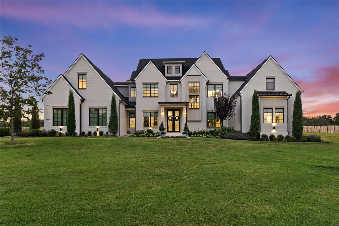 Step into luxury with this magnificent estate, set on 1.5 acres of lush, landscaped grounds. Conveniently located just minutes from Downtown Fayetteville, I-49, this home provides a seamless blend of country tranquility and urban convenience. Designed with elegance in mind, the home features French oak floors, designer lighting, and beautiful arches throughout. Each bedroom is a serene retreat with walk-in closets, and the bathrooms offer a touch of luxury with marble floors. This estate’s superior design has earned two awards from the Arkansas Interior Design Society. The outdoor space is a true haven for entertaining and relaxation, with an 18x36 heated gunite pool, a fire pit, a pergola with a grill station and outdoor beverage refrigerator, and a putting green for golf practice. With ample space for hosting gatherings and enjoying luxurious outdoor amenities, this home epitomizes sophisticated living. Schedule your private tour today to experience the unparalleled luxury of this award-winning estate.