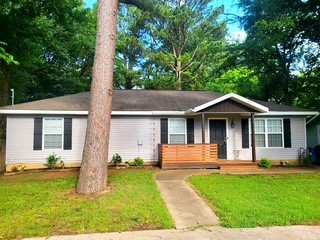 What a fantastic location for this wonderful cottage.  Plenty of room for a family or would make an excellent investment property just minutes from the downtown square and the University.  Newly remodeled throughout including a brand new April 2026 Bonus room off the kitchen and a brand new April 2026 HVAC.  The Bonus room would make a perfect office overlooking the lush backyard.  Granite countertops, laminate wood floors, fenced in yard and tons of natural light.  Just a short drive to a variety of restaurants,the downtown square, parks and the UofA!  This charming property is in move in condition!