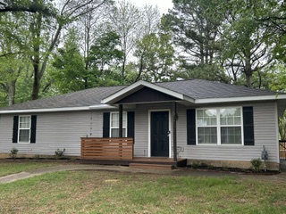 What a fantastic location for this wonderful cottage.  Plenty of room for a family or would make an excellent investment property just minutes from the downtown square and the University.  Newly remodeled throughout including a brand new April 2026 Bonus room off the kitchen and a brand new April 2026 HVAC.  The Bonus room would make a perfect office overlooking the lush backyard.  Granite countertops, laminate wood floors, fenced in yard and tons of natural light.  Just a short drive to a variety of restaurants,the downtown square, parks and the UofA!  This charming property is in move in condition!