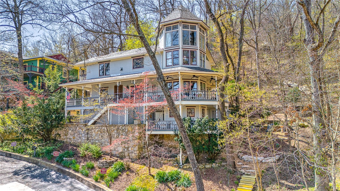 Welcome to the Top-Rated Arsenic and Old Lace. This lodging property is a REPEAT MEDAL WINNER OF Best of NWA, including BEST Lodging, BEST Romantic Getaway & BEST B&B. This highly profitable property has a loyal customer base & impressive financial performance. Combined with a newly updated & private innkeeper's quarters, it's set up for long term success & solid return on investment for new owners.
Lavish & welcoming with 5 guest suites, each with carefully remodeled bathrooms. Your guests will enjoy the bright & comfortable eating area with lovely fireplace, perfect for breakfast and gathering. Stunning back living area has direct access to the Spring Garden Trail, which provides an easy walk to downtown! Tesla car chargers(only ones in Eureka Springs) and trolley stop, provide superior convenience too! This would also make an incredible family home!  Space for all & incredible experience living in Eureka Springs! Being sold furnished. Located in one of the top vacation destinations in Arkansas!