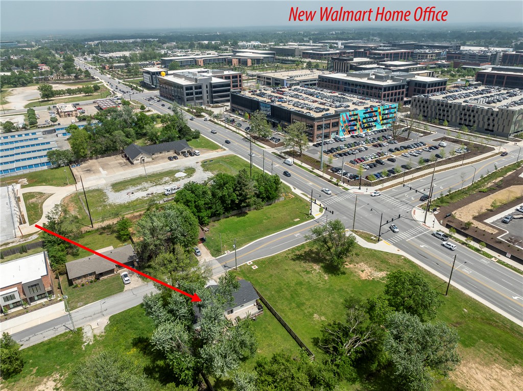 Rare Development Opportunity Near Walmart Home Campus  Positioned minutes from the new Walmart Home Campus, this property offers an exceptional opportunity in one of Bentonville’s most explosive growth corridors. With surrounding development, this level 0.25-acre parcel presents strong potential for redevelopment, new construction, or long-term investment.  The existing 3-bed, 2-bath, 1,312 sf home is being sold as-is & can provide interim rental income or serve as a holding asset while future plans are finalized. Recent updates include HVAC ‘26, most windows replaced (2024), garage door (2024), sliding door (2024), and stove (2024).  The lot itself is flat, fenced, and features a large deck, offering a clean slate for future development. Utilities are in place, enhancing ease of redevelopment.  Unmatched location with immediate proximity to the Walmart Home Campus & access to I-49. Bike or walk to The Momentary, 8th Street Market, Thaden School & Historic Bentonville City Square.