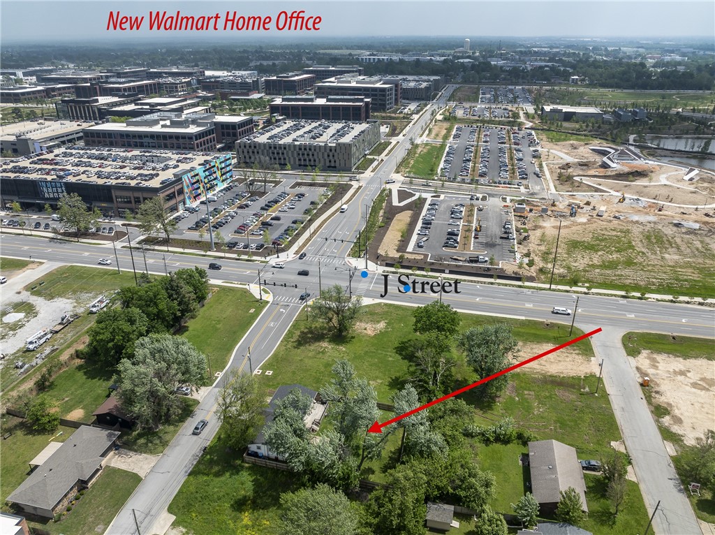 Rare Development Opportunity Near Walmart Home Campus  Positioned minutes from the new Walmart Home Campus, this property offers an exceptional opportunity in one of Bentonville’s most explosive growth corridors. With surrounding development, this level 0.25-acre parcel presents strong potential for redevelopment, new construction, or long-term investment.  The existing 3-bed, 2-bath, 1,312 sf home is being sold as-is & can provide interim rental income or serve as a holding asset while future plans are finalized. Recent updates include HVAC ‘26, most windows replaced (2024), garage door (2024), sliding door (2024), and stove (2024).  The lot itself is flat, fenced, and features a large deck, offering a clean slate for future development. Utilities are in place, enhancing ease of redevelopment.  Unmatched location with immediate proximity to the Walmart Home Campus & access to I-49. Bike or walk to The Momentary, 8th Street Market, Thaden School & Historic Bentonville City Square.