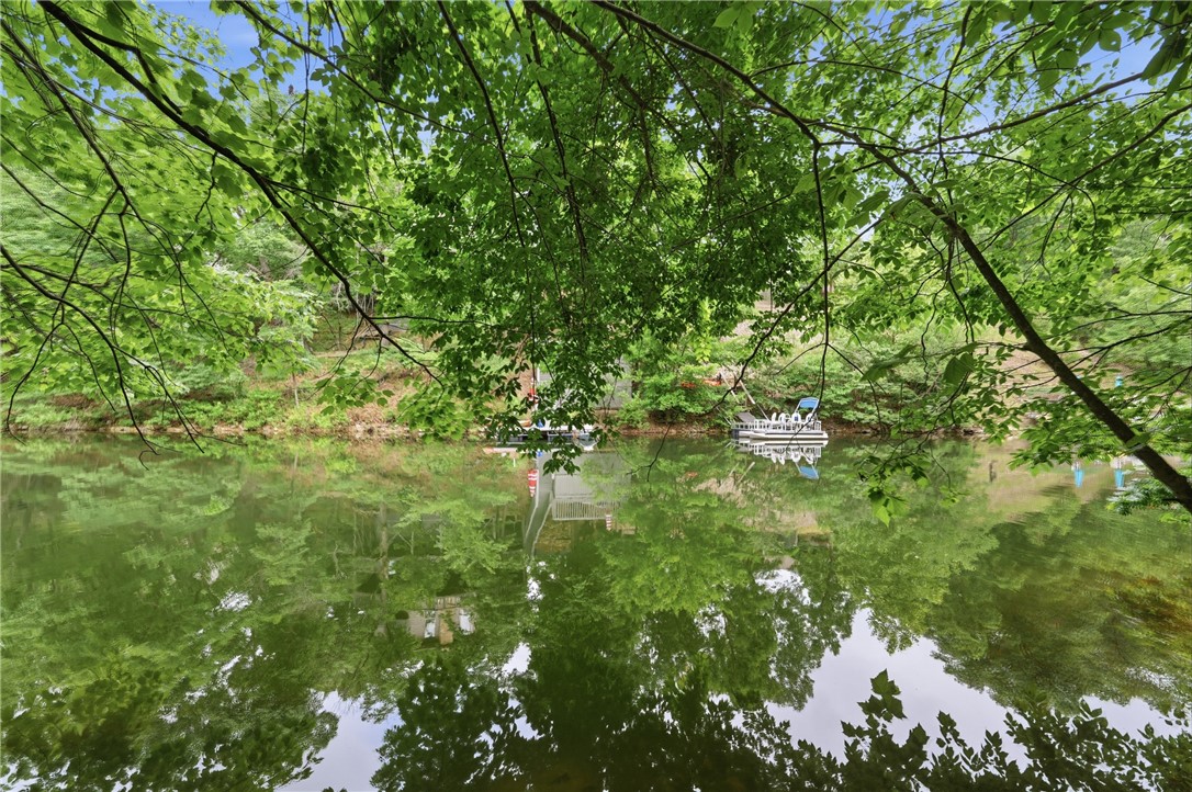 Lakefront lot on Lake Brittany! Featuring 47 ft of shoreline on one of Bella Vista's most peaceful lakes, this property is stocked with trout & reaches 75 ft depths—ideal for catching bass right from your backyard. Bring your vision to life on this incredible lot, perfect for a custom lakefront retreat with premium access for fishing, canoeing, kayaking, paddleboarding, or anchoring your pontoon.
Nestled in a serene neighborhood, this location is an outdoor paradise. Cyclists will love the immediate proximity to NWA's world-class trails: Back 40, Pinyon Creek, The Ledges, Rego, & Blowing Springs Greenway.
Golfers are perfectly positioned near Dogwood & Brittany courses, plus under 15 minutes to Tanyard Creek, Bella Vista Country Club, Kingswood, & Berksdale. Whether you're a golfer, biker, angler, boater, or just love Ozark beauty, this lot offers the ultimate NWA lifestyle. Don't miss this rare opportunity on Lake Brittany!