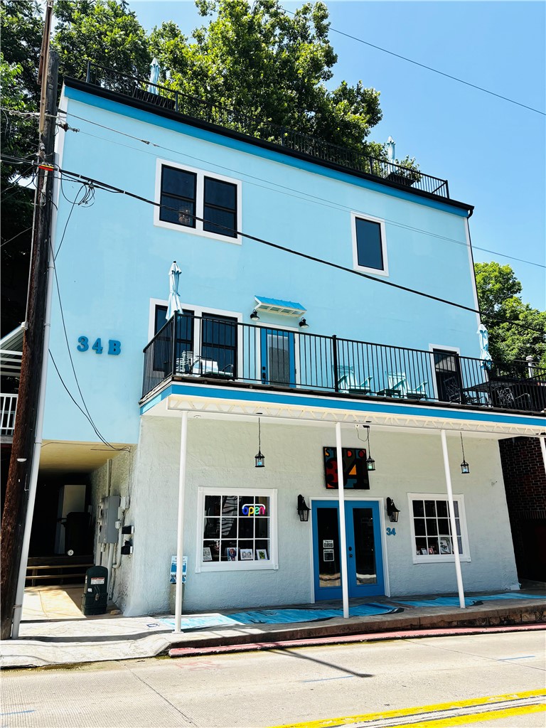 Experience luxury living with exceptional investment potential in the heart of Historic Downtown Eureka Springs. This beautifully renovated mixed-use building features two upper levels currently serving as a private residence, with the second floor designed for short-term rental or Airbnb use. Sold fully furnished, the upper levels offer a true turnkey opportunity. The main level includes a 700 sq. ft. retail space currently operating as a successful art gallery. Modern finishes, soaring ceilings, extensive renovations, and a private rooftop with breathtaking downtown views create a one-of-a-kind property. Three off-street parking spaces, a rare downtown amenity, add unmatched convenience. Prime location with high pedestrian traffic makes 34 Main Street an extraordinary opportunity to live, invest, and thrive. If you have ever dreamed of living in Eureka Springs, now is your chance. So Don't wait, opportunities like this don't last long! 

Also listed as Commercial MLS 1353890