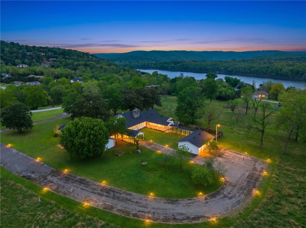 Extraordinary development opportunity! Featuring approximately 13.81 acres surrounded by the beauty of Table Rock Lake!! This unique property offers incredible potential for future development, whether expanding into a private estate, subdividing, or creating a high-end retreat or short-term rental community. The existing 6,200+ sq ft home provides a strong foundation with 4 bedrooms, 3.5 baths, multiple living areas, and lake views from several rooms. The gently rolling, usable land allows flexibility for additional structures, amenities, or investment expansion. With public utilities available and a prime location near lake access and recreation, this property combines immediate livability with long-term upside—an exceptional opportunity to create something truly special in one of Northwest Arkansas’s most scenic lake areas.