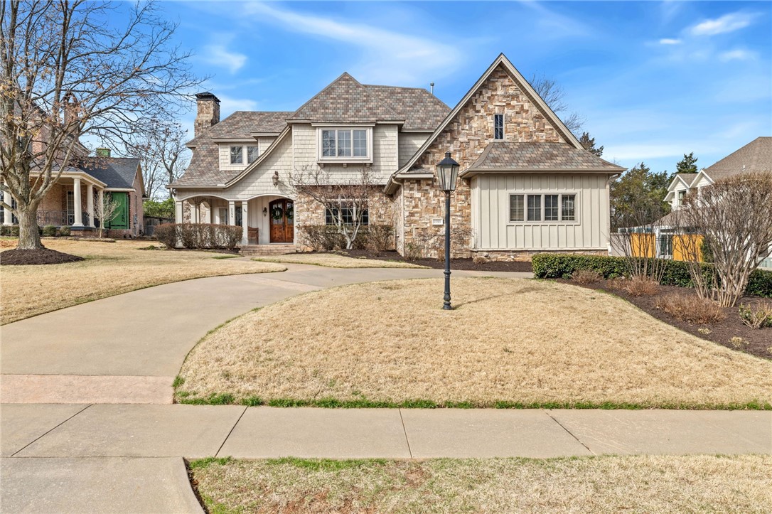 Set in central East Fayetteville, this 4,370 SF home in the sought-after Candlewood neighborhood manages to feel both substantial and genuinely welcoming. At the charming entrance a covered front porch invites you to sit and meet your new neighbors. Inside, you’ll find 4 bedrooms, 3.5 baths, a generous study with fireplace, formal and casual dining rooms, a bonus room, and a tucked-away office nook by the kitchen. The kitchen is built for real cooking: 6-burner gas range with vent hood, wall oven plus convection microwave, trash compactor, sonic ice machine, and a cabinet-trimmed subzero refrigerator, with a full-size freezer separately in the utility room. The main living area centers on a large stone fireplace and opens to a wide covered back porch with TV and a big, usable yard. Upstairs is ready for game nights & sleepovers with a fridge, built-ins, sectional, and foosball table in the bonus room. A neighborhood walking trail connects directly to Vandergriff Elementary school.