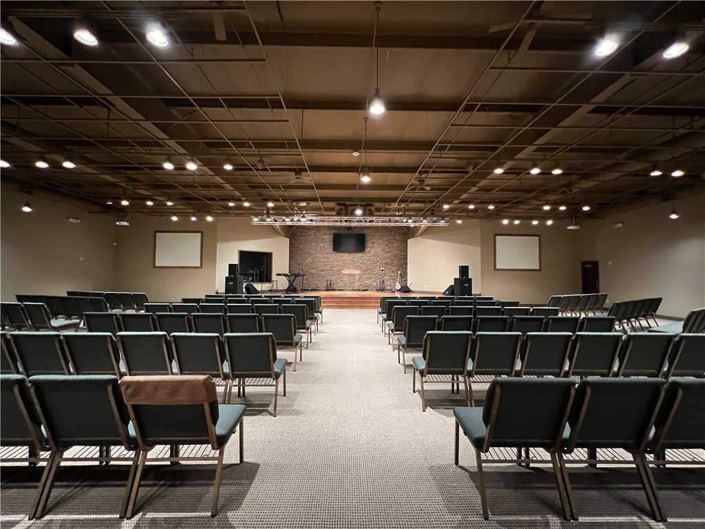 Must see property! This 19,224 sq ft upgraded building on 1.93 acres has unlimited potential! This is a rare finding in this area! Currently used as a church with over 1200 sq ft of office space on the first floor, a bookstore, area for nursery, children's ministry, youth department, classroom/conference room, various storage areas and a laundry area.  It features a central gathering area, with full kitchen and very inviting and relaxing cafe-like area of over 3500 sq ft which is a great place to entertain, mingle or provide a great meal with the full kitchen available.  The main sanctuary boasts over 4600 sq ft comfortably seating over 300 guests. The platform has hardwood flooring, and a beautiful stack rock wall. Property is just 5 mins to-I49 for easy access. Once a skating rink this could be transformed into almost any type of business, day care, gym, or manufacturing facility. With properties of this quality becoming scarcer in the area this one won't last long!! Come and see this before it's gone!!