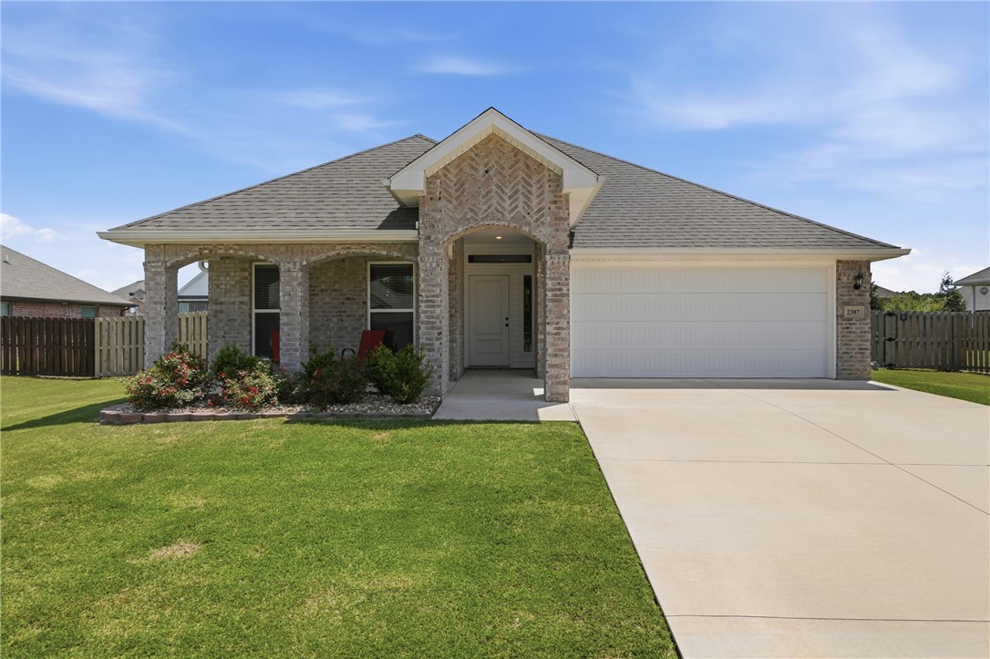 Welcome home to this well-maintained 3 bed, 2 bath brick beauty nestled on a generous .26-acre lot! The full brick exterior and covered front porch set the tone for the quality and care found throughout. Step inside to discover tile flooring flowing through the living areas, kitchen, and wet areas which are both beautiful and easy to maintain. The thoughtful layout offers comfortable living spaces, including an eat-in kitchen with island and pantry. The primary suite and bath features dual vanities, walk in shower, soaker tub, and large closet. Covered front and back porches are perfect for morning coffee or evening relaxation. The privacy-fenced backyard provides a safe and secluded retreat for kids, pets, and outdoor entertaining. An outdoor storage shed also conveys, providing even more room for tools, lawn equipment, and more. Located just minutes from Pea Ridge schools and everyday conveniences, this home checks every box.