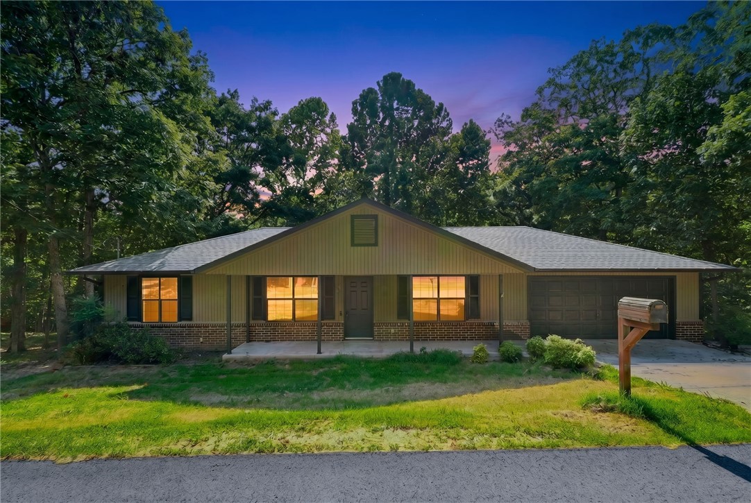Tucked into a quiet stretch of Bella Vista's Rugby subdivision, this fully refreshed 3-bedroom, 2-bath home sits on a peaceful, tree-lined 0.32-acre lot with minimal visible neighbors and mature oak and maple cover. Nearly everything has been updated: a brand-new architectural shingle roof (4 months old), a new HVAC system, and all-new luxury vinyl plank flooring set the stage for easy living. The kitchen showcases brand-new 3CM quartz counters, a new backsplash, undermount sinks, a new dishwasher, and an electric range that conveys. Fresh interior paint, new LED lighting, and ceiling fans carry the refresh through every room, while the primary bathroom's new walk-in shower adds a polished finishing touch. Outside, enjoy a covered front patio, a covered back deck, a storage building, and access to the community pool. Minutes from Blowing Springs Park, Back 40 trails, and Sugar Creek Center, with easy access to Bentonville. POA dues paid monthly.