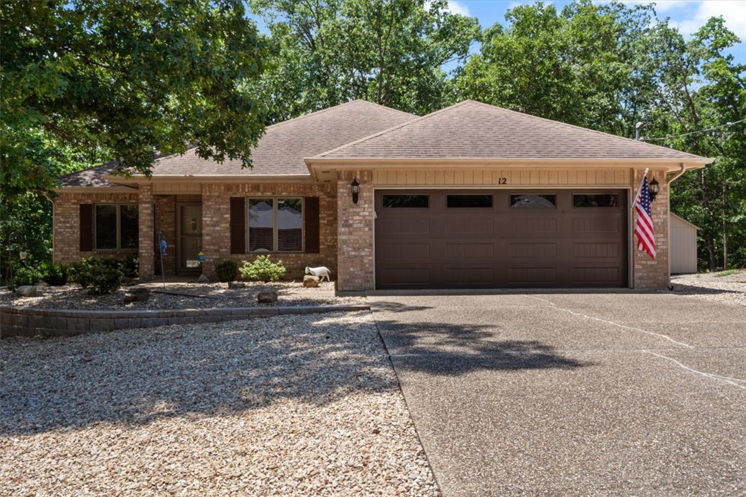 Lovingly cared for, quality built, pristine home on a 1/2 acre park like setting on a quiet cul-de-sac with tons of updates including HVAC, sump pump, hardwood flooring, trim, paint, insulation, hot water heater, complete kitchen renovation with quartz countertops, backsplash, sink, hardware, cabinets, double oven and microwave. New gutter guards, garage doors, double oven, microwave and vent, cabinets, grinder pump. New quartz countertops, sinks, cabinets, hardware, lighting and toilets in both bathrooms. New ceiling fans, new electrical panel, breakers, switches and outlets. New landscaping and retaining wall. Newly stained covered deck overlooking beautiful forest views. Near bike trails. On sewer. Bentonville Schools. Maintenance free yard with wonderful curb appeal.  Excellent location with easy access off of Hwy 71. This lovely, completely updated home has it all and is waiting for you, but not for long.