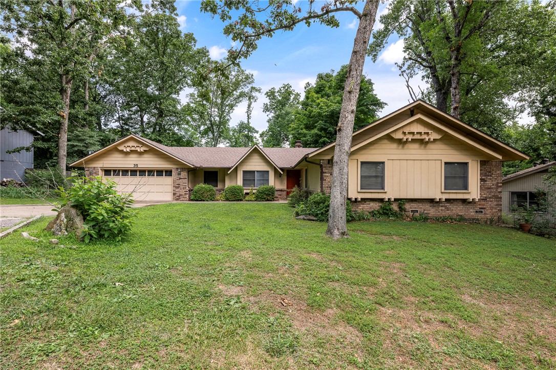 Looking for a home with great bones with the opportunity to add your own style? This Bella Vista value is move-in ready today, with plenty of potential to build equity through future updates. Situated on a private 0.30-acre lot, this home offers a spacious living area highlighted by a dramatic floor-to-ceiling fireplace, creating a warm and inviting focal point for gatherings. Step outside to enjoy the large covered deck and enjoy the natural beauty that Bella Vista is known for. Improvements have already been made, including a roof that's approximately 3 years old and a new water heater recently installed. Even better, the refrigerator, washer, and dryer are included, creating more value. The location is hard to beat, with easy access to Bentonville schools, shopping, dining, and everyday services. Outdoor enthusiasts will appreciate being close to mountain biking trails, Big Sugar Creek, Kingswood Golf Course, and the Bella Vista Recreation Center featuring swimming, fitness facilities, and more.