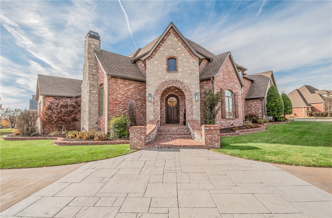 Located on a spacious corner lot in the refined haven of Pinnacle Country Club, this French inspired estate captivates w/its signature symmetrical design, steeply pitched roofs and stone & brick facade. The elegant 4,703 sf interior is designed for comfort & style and adorned with newly refinished hardwood flooring, updated designer paint palette, plantation shutters and boasts high ceilings w/ornate moldings & expansive windows. Formal living areas embellished w/cast stone fireplaces & designer fixtures seamlessly connect w/a cozy reading loft & home theater, creating a harmonious balance between grand entertaining & intimate relaxation. The heart of the home is the gourmet kitchen, equipped w/high end appliances integrated into custom cabinetry & bay window dinette that opens to a spacious covered veranda for alfresco dining.  The manicured property includes lush landscape beds, separate gated lawn space, covered veranda, balcony terrace & a gorgeous heated pool, providing a serene backdrop for outdoor leisure.