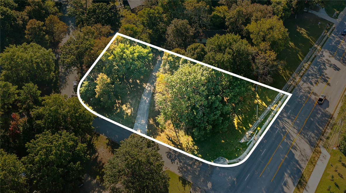 Fantastic opportunity to own property right off Crossover in East Fayetteville! Build, hold, or purchase the home and lot behind it to own the whole acre. The opportunities are truly endless with this rare piece of flat, corner, land. Around 25k annual average daily traffic on this highway does all your advertising for you if you plan to open a business, produce multi family housing, or any commercial venture you can imagine! See attached lot split for more information.  MLS #1321359
