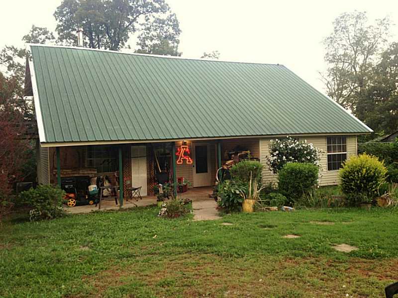 Secluded home and 3 acres just 6 miles from I49. Loft could be 4th bedroom. Upstairs and downstairs decks. Master is on 2nd floor. 10x16 storage building. Fenced area for pets. Could have a horse or cow here. A lot of house for the money.