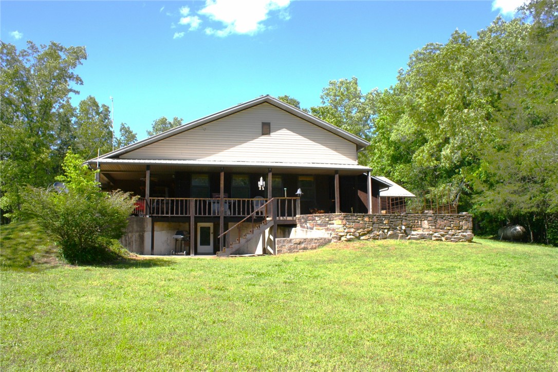 10 Acre tranquility at it's best, within minutes of Pruitt Buffalo River trailhead and launch.  This is a solid home built with 2x6 studded walls and hurricane clips placed on rafters, attic fans thermostatically controlled, 5 ton HVAC system.  Storm shelter placed under home.  Enjoy the feeling of seclusion, trees surrounding property.  Beautiful clearings with grass along two creeks.  Sit on the back patio and listen to the babbling creek while you watch wild life in the cleared openings.  Garden/flower spot right off the back patio, easy maintenance and watering.  Custom walk-in shower built with flat rock off property and all natural cedar wood walls.  No mud to deal with, massive parking area all concrete.   Must see to appreciate!!